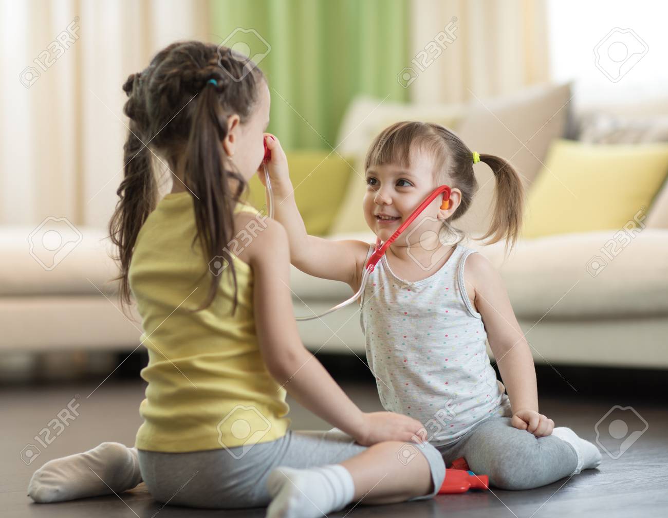 two kids girls playing doctor at home child toddler girl examining children play doctor