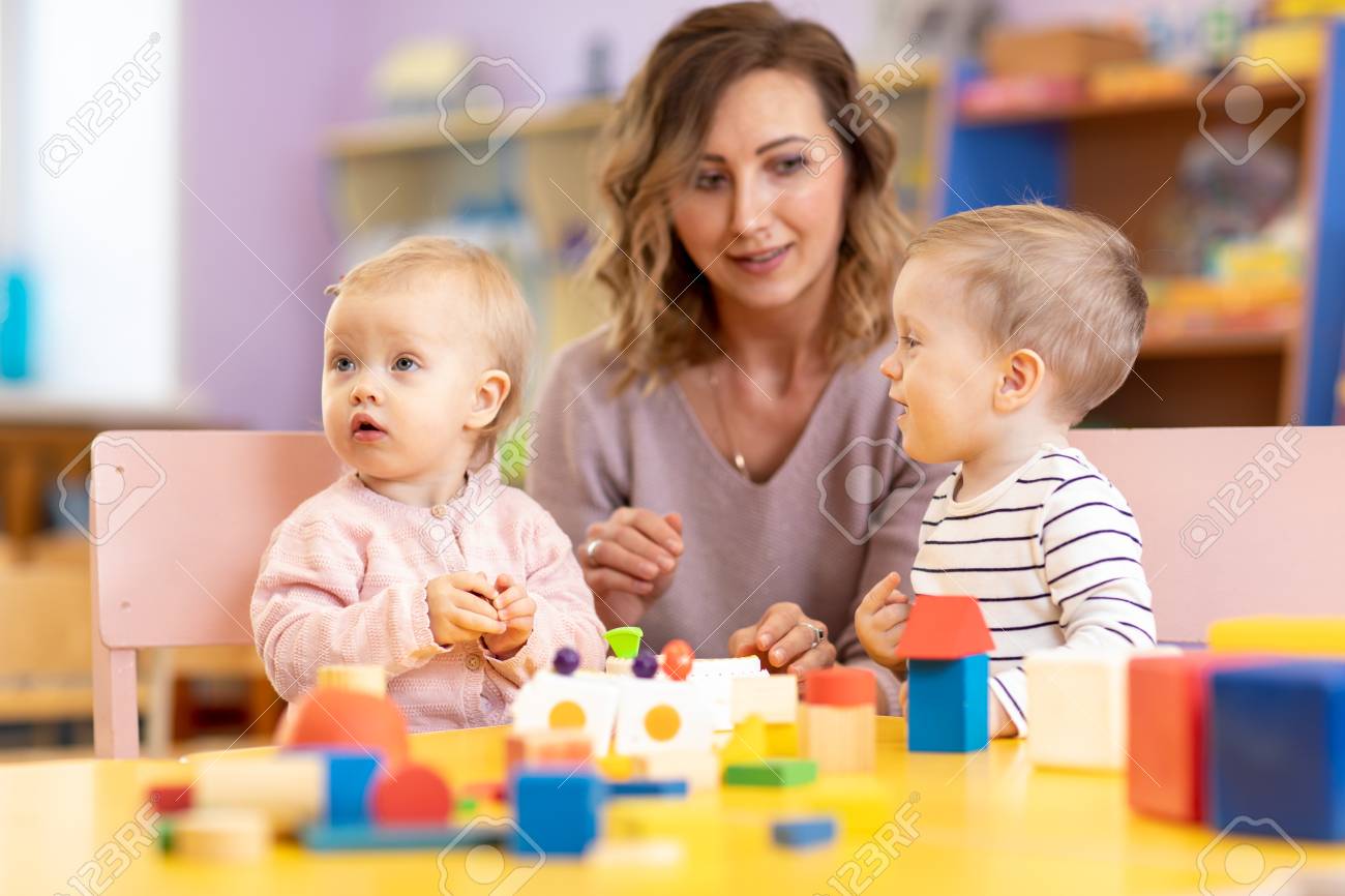 children toddlers with kindergarten teacher is playing with montessori teacher toddler