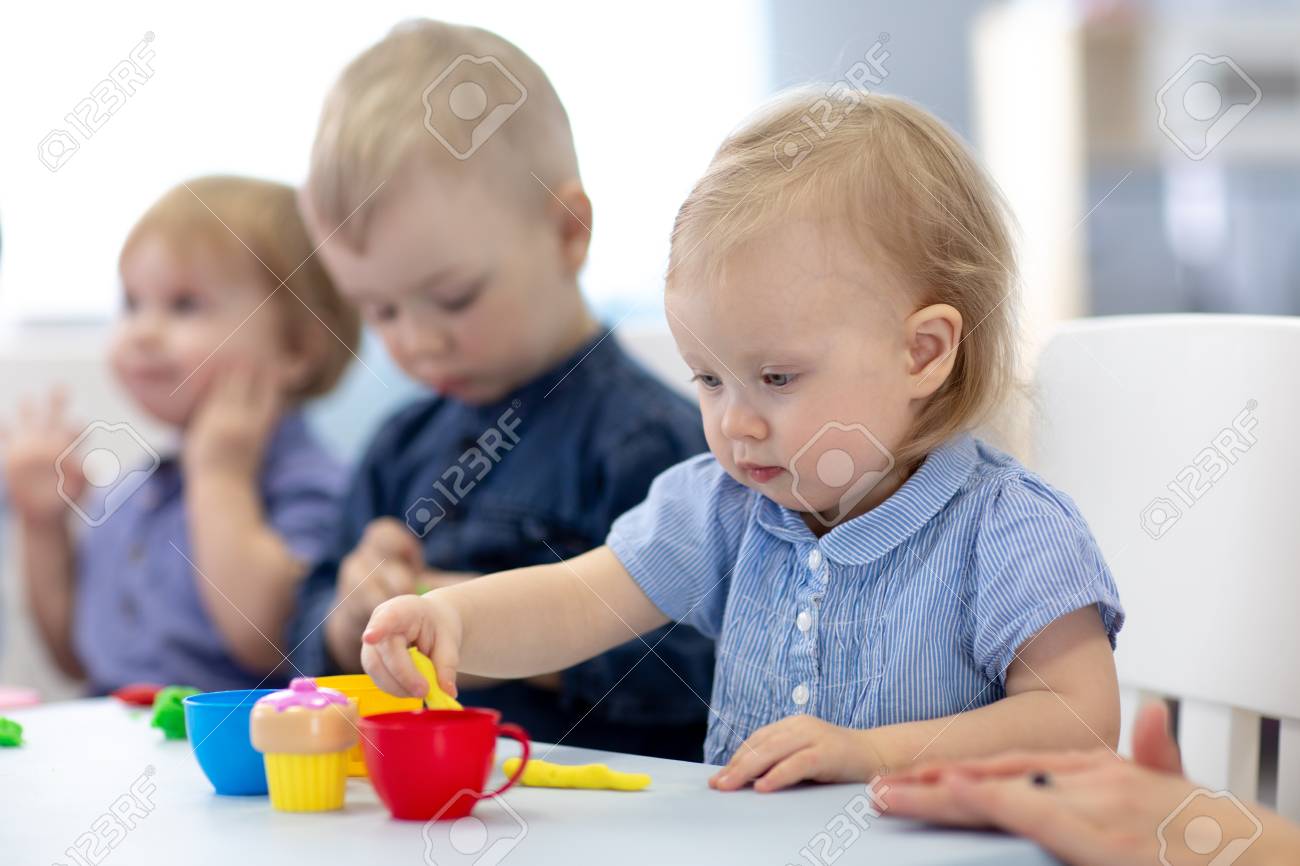 Group of babies kids engaged in handcrafts - 122596895 Group of babies kids engaged in handcrafts - 122596895