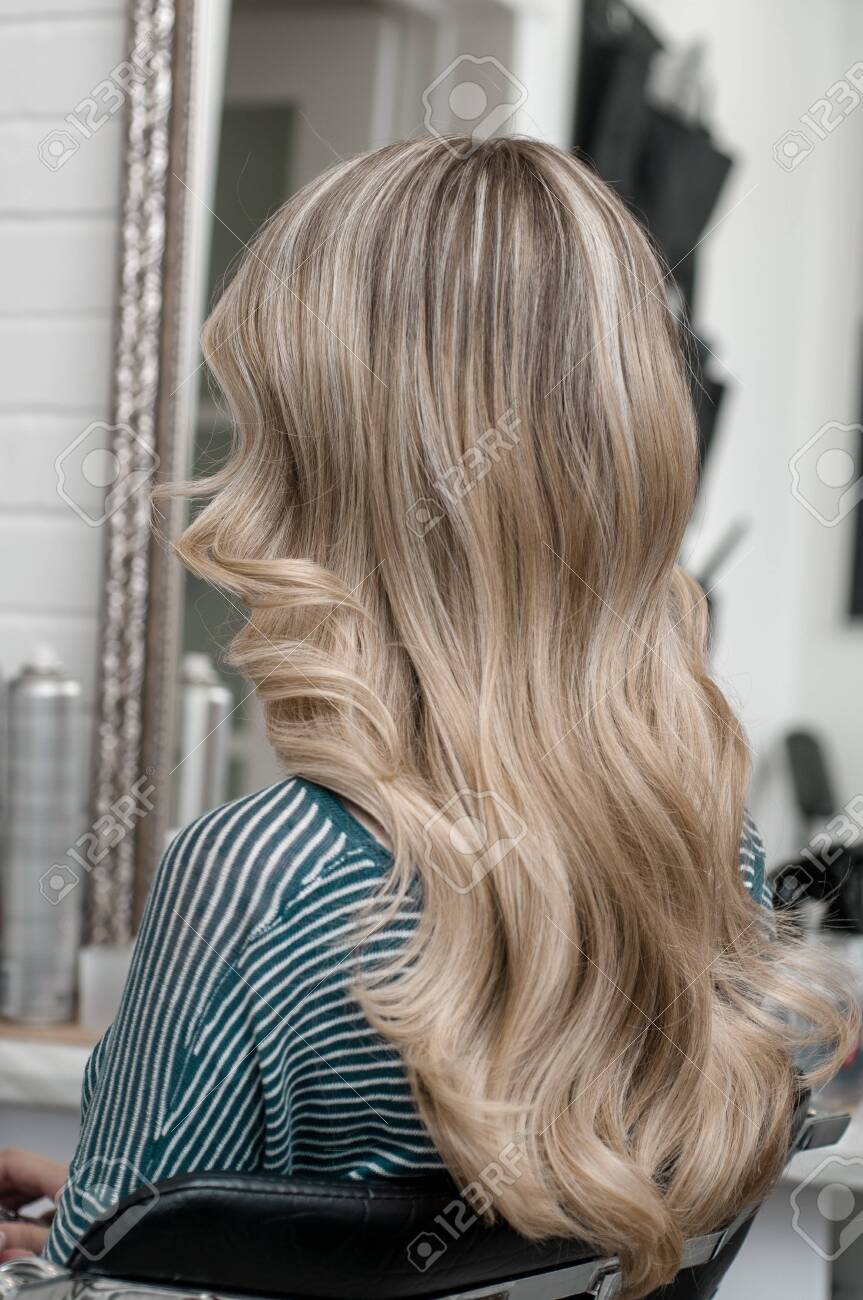 Blonde Girl With Long Hair In A Beauty Salon With Wave Hairstyle