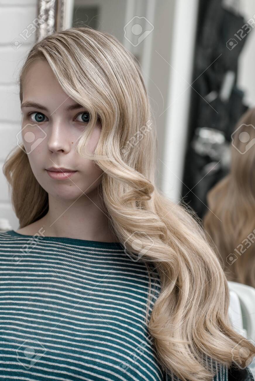 Blonde Girl With Long Hair In A Beauty Salon With Wave Hairstyle