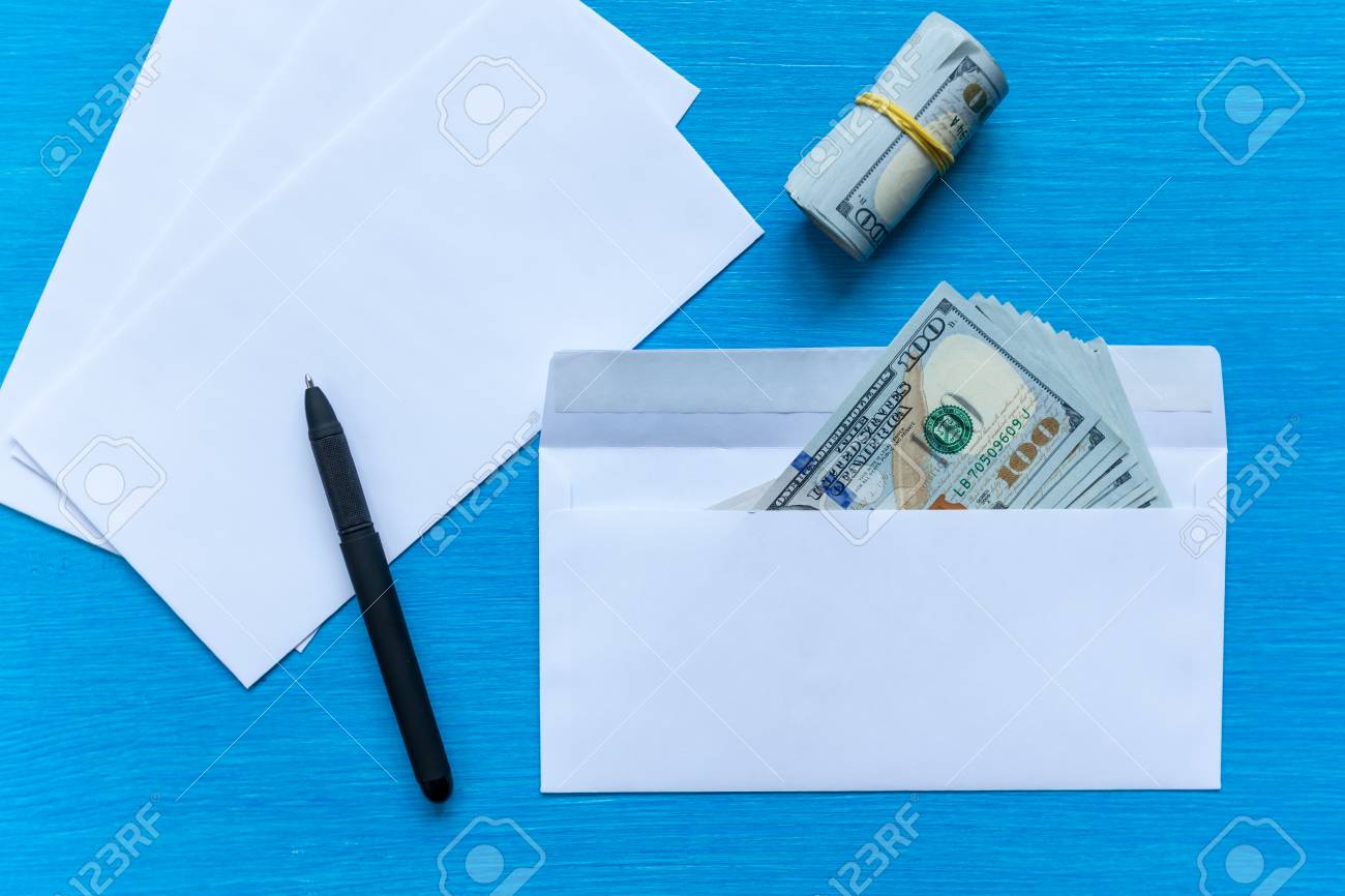 white envelopes with money lie on a black wooden table bribe envelope with money