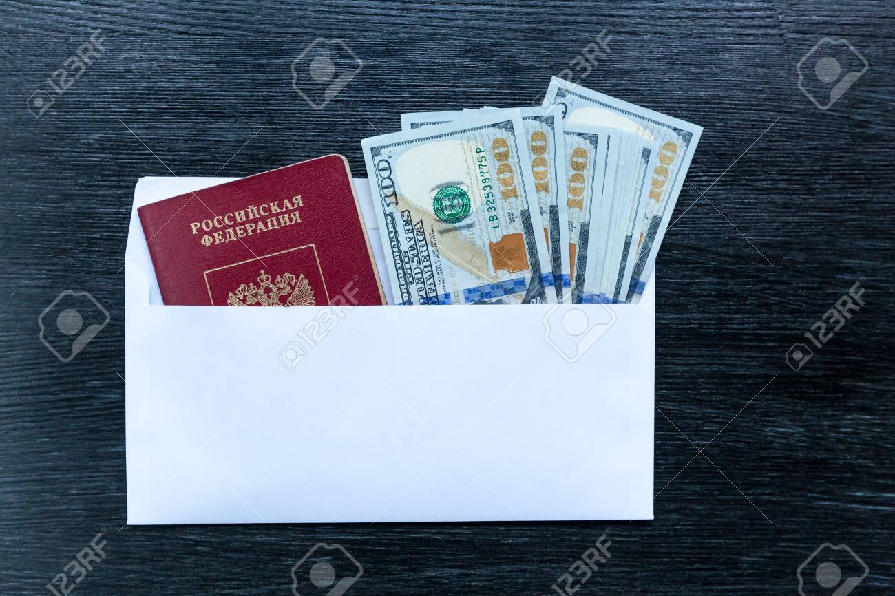 visas in foreign passports and an envelope with money are on envelope with money