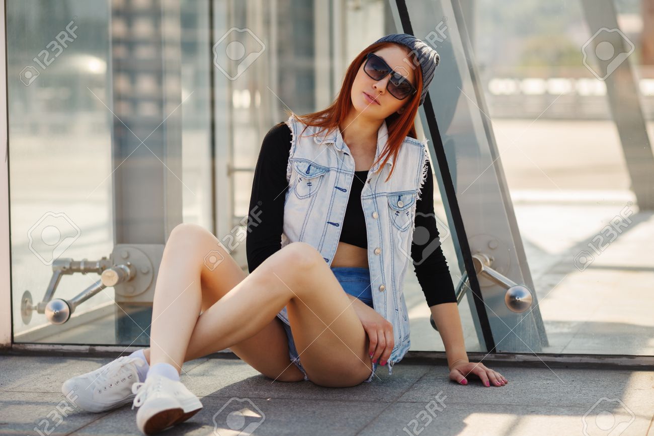 Outdoor fashion lifestyle portrait of pretty young girl, wearing in hipster swag grunge style urban