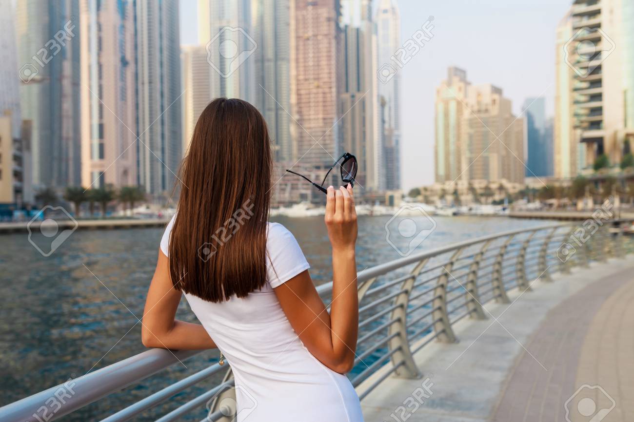 Happy Beautiful Unrecognizable Tourist Woman In Fashionable Summer White Dress Enjoying In Dubai Marina In United Arab Emirates Luxury And Comfortable Tourism Season In Uae Stock Photo Picture And Royalty Free Image