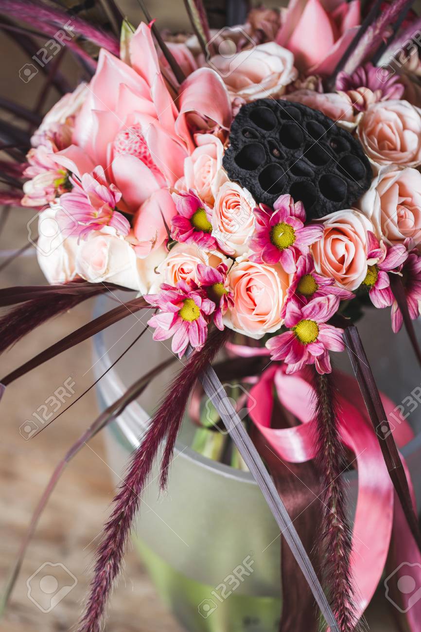 wedding bouquet in boho style with pink silk ribbons roses