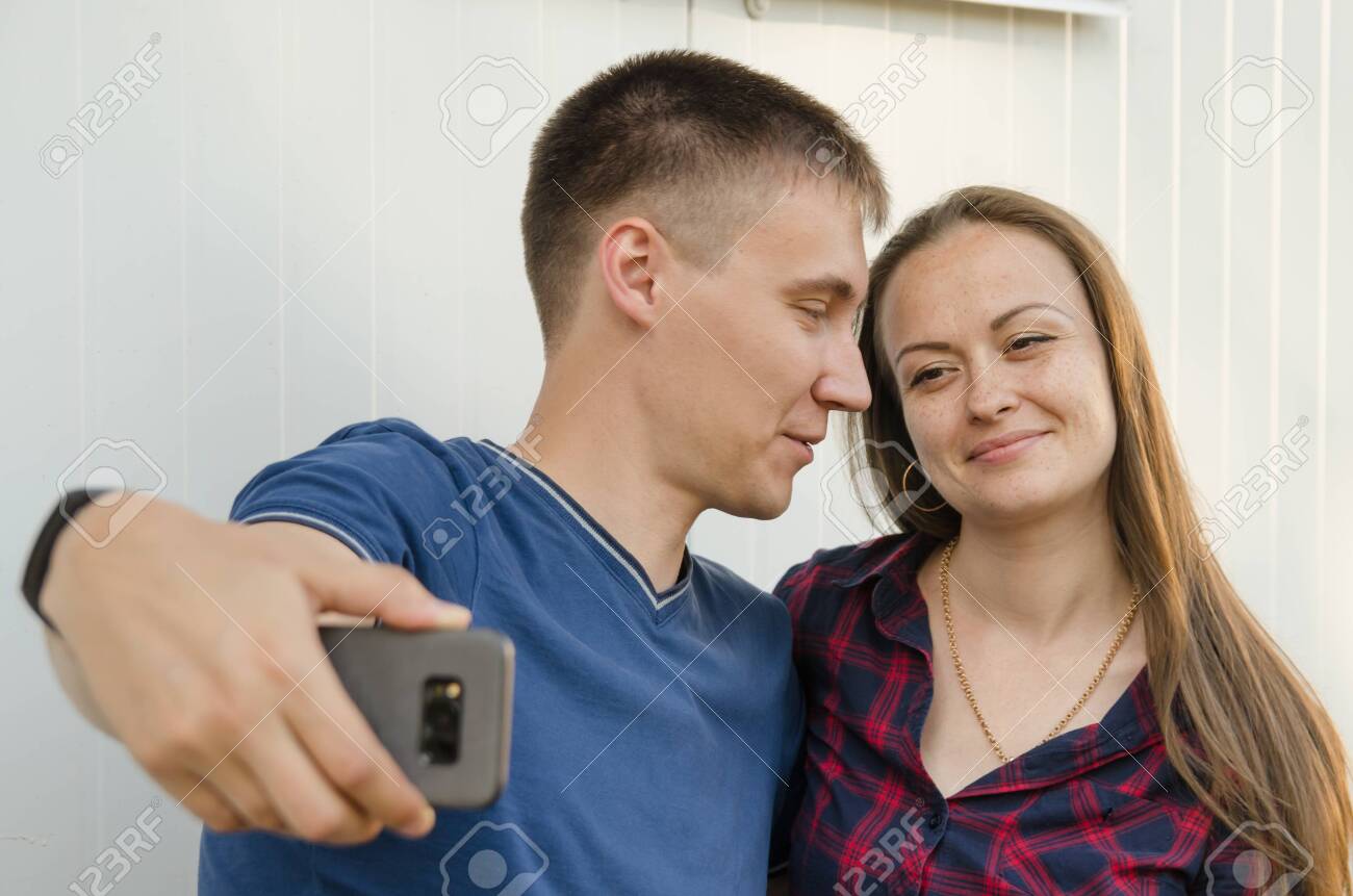 Guy With Short Haircut In Blue T Shirt And Girl With Dark Long