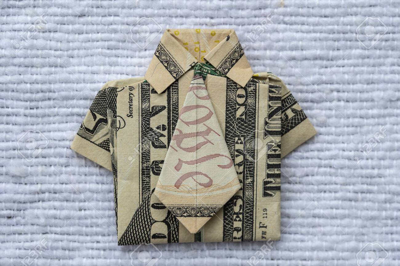 Origami Shirt Made Of Dollar Banknote On White Fabric Background