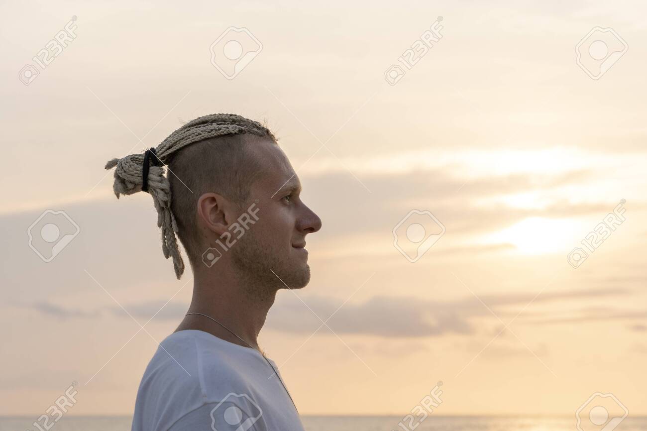 Silhouette Of A Young Guy With Dreadlocks On His Head Near Sea