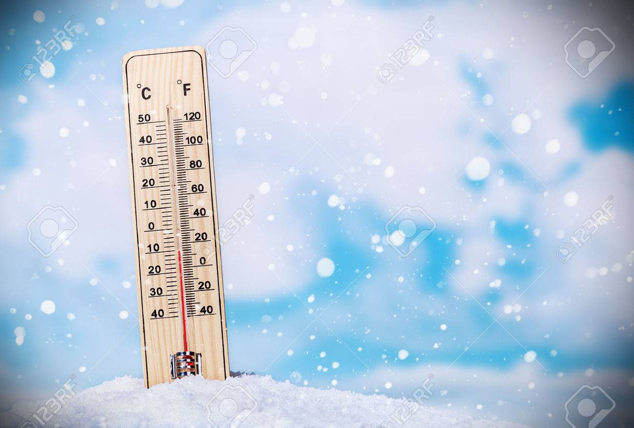 Thermometer on snow shows low temperatures on the sky with clouds - 33726749 Thermometer on snow shows low temperatures on the sky with clouds - 33726749