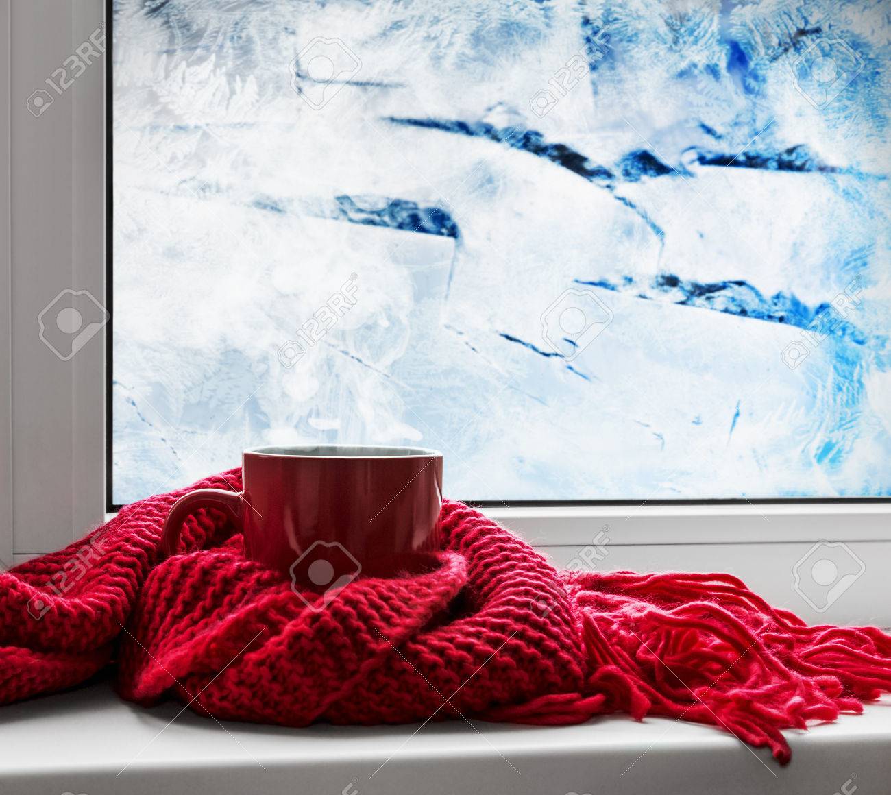 red cup with hot drink on the background of frozen window - 44715027 red cup with hot drink on the background of frozen window - 44715027