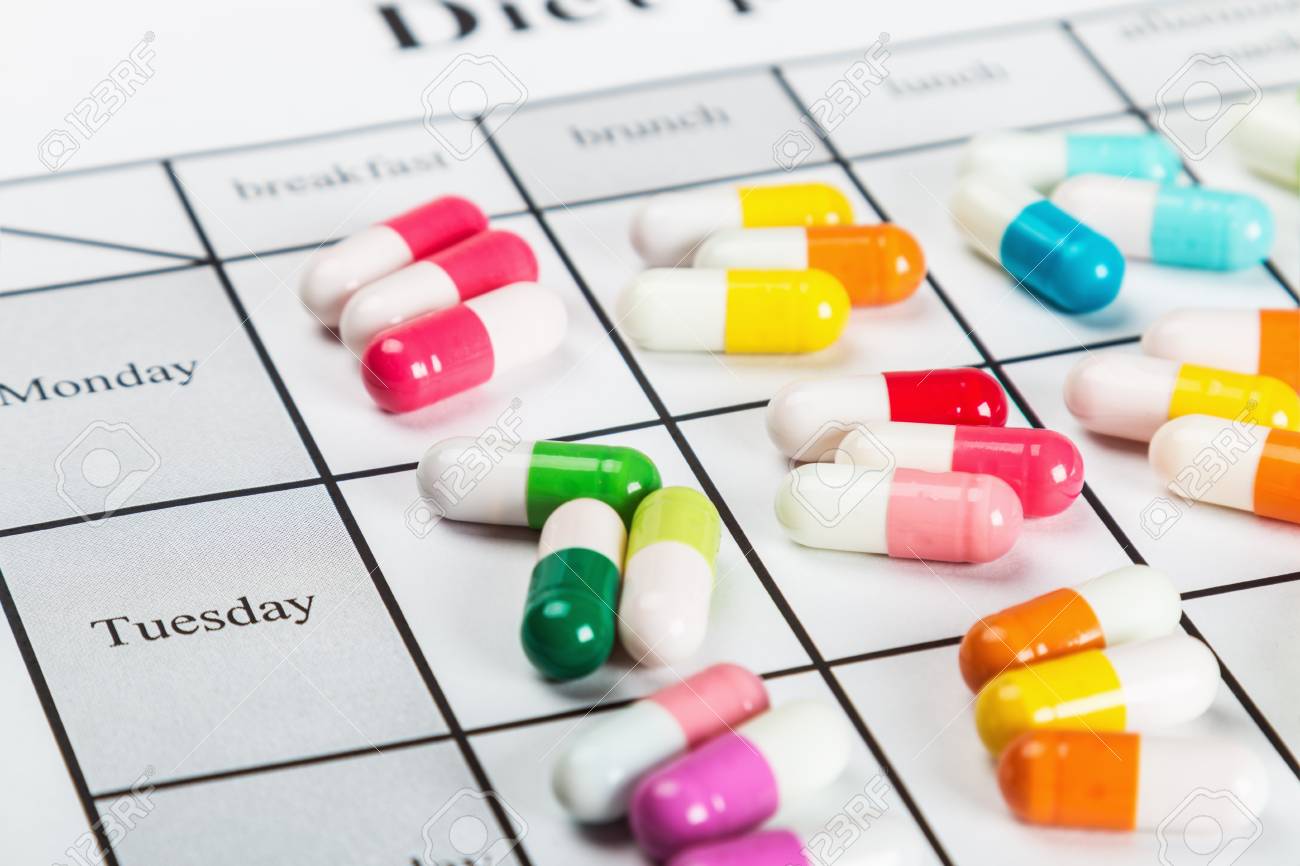 pills of different colors on a calendar medication stock photo pill calendar