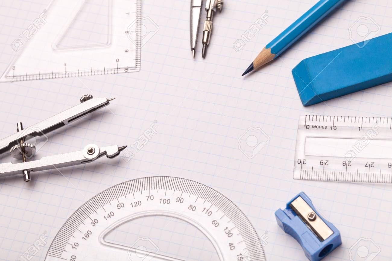 mathematical instruments surrounding a graph paper creating copy