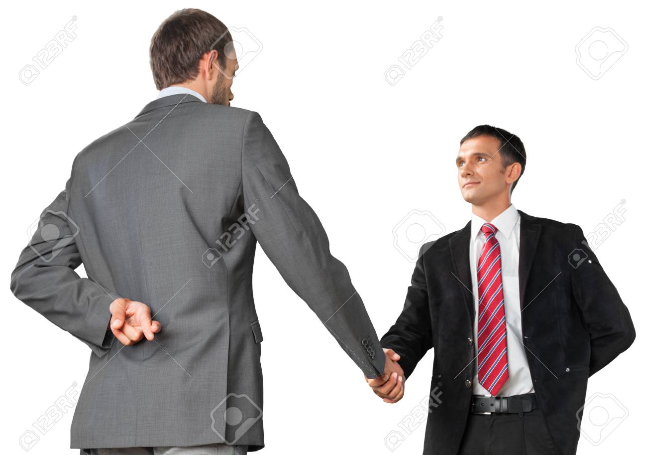 104626928-portrait-of-two-businessmen-shaking-hands-while-crossing-fingers-behind-back.jpg