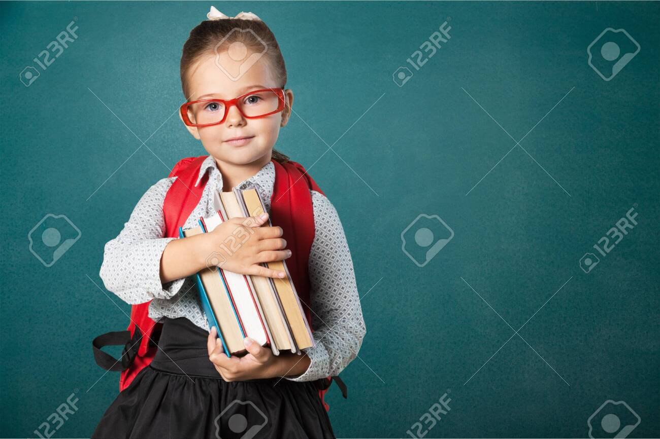 Cute little schoolgirl in glasses on blackboard - 124300888 Cute little schoolgirl in glasses on blackboard - 124300888