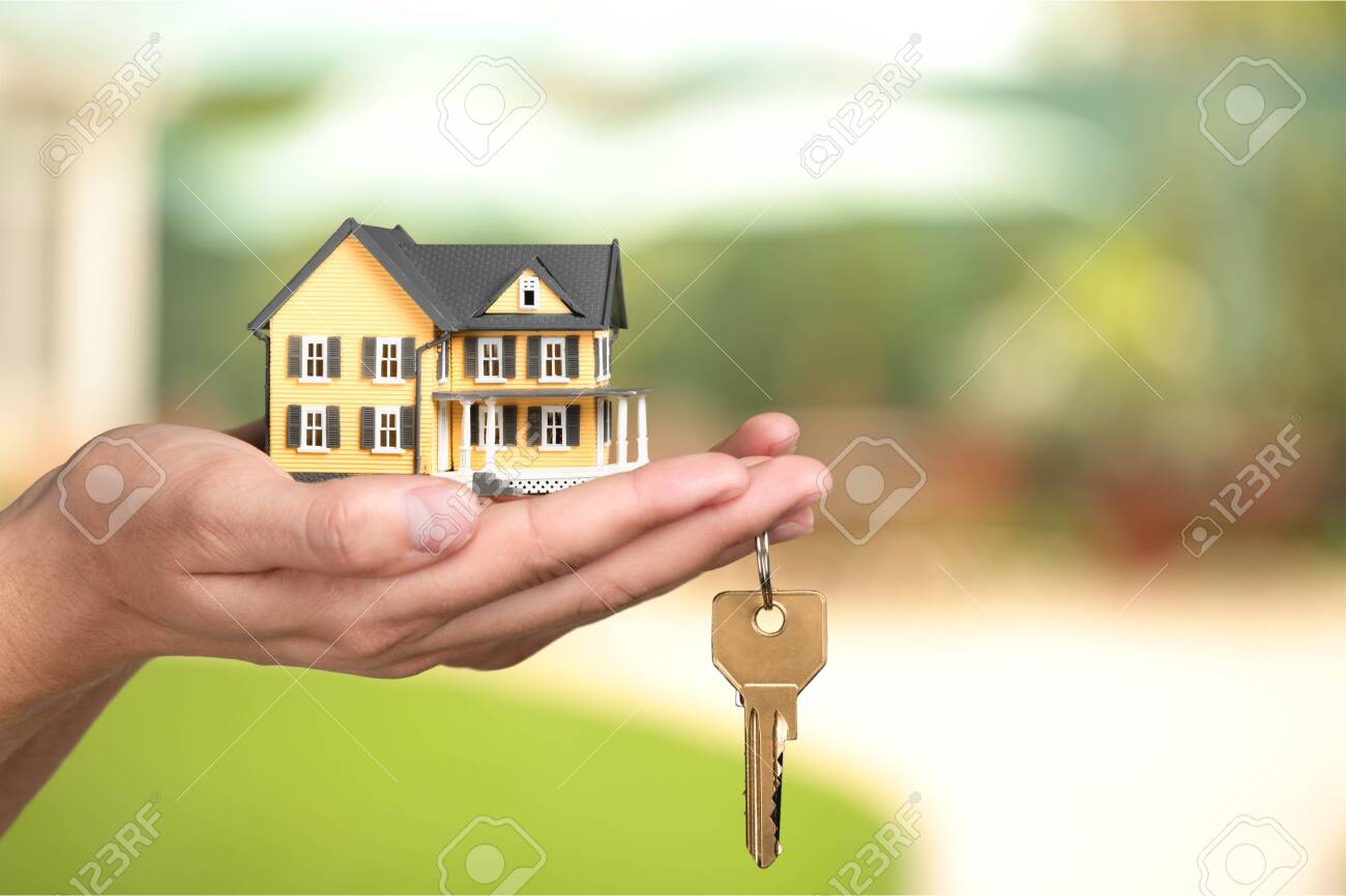 Businessman Holding House Model and Keys, Real - 124314287 Businessman Holding House Model and Keys, Real - 124314287