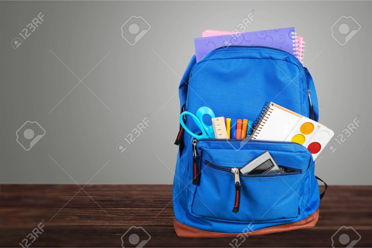 Open blue school backpack on wooden desk - 128027025 Open blue school backpack on wooden desk - 128027025