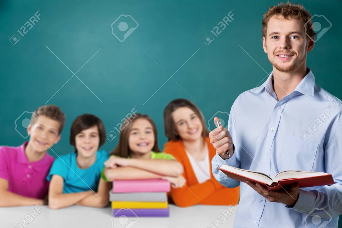 Young male teacher and school child - 129160597 Young male teacher and school child - 129160597