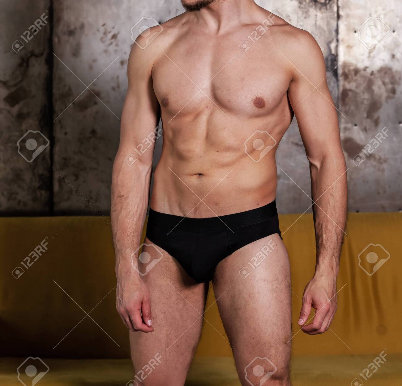 Good Looking Naked Man Revealing Sixpack Abs And Wearing Briefs. Black  Underwear For Men. Stock Photo, Picture and Royalty Free Image. Image  156023145.