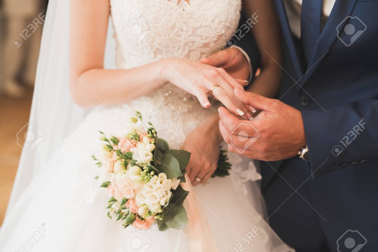 Bride and groom exchanging wedding rings. Stylish couple official ceremony - 101371446 Bride and groom exchanging wedding rings. Stylish couple official ceremony - 101371446