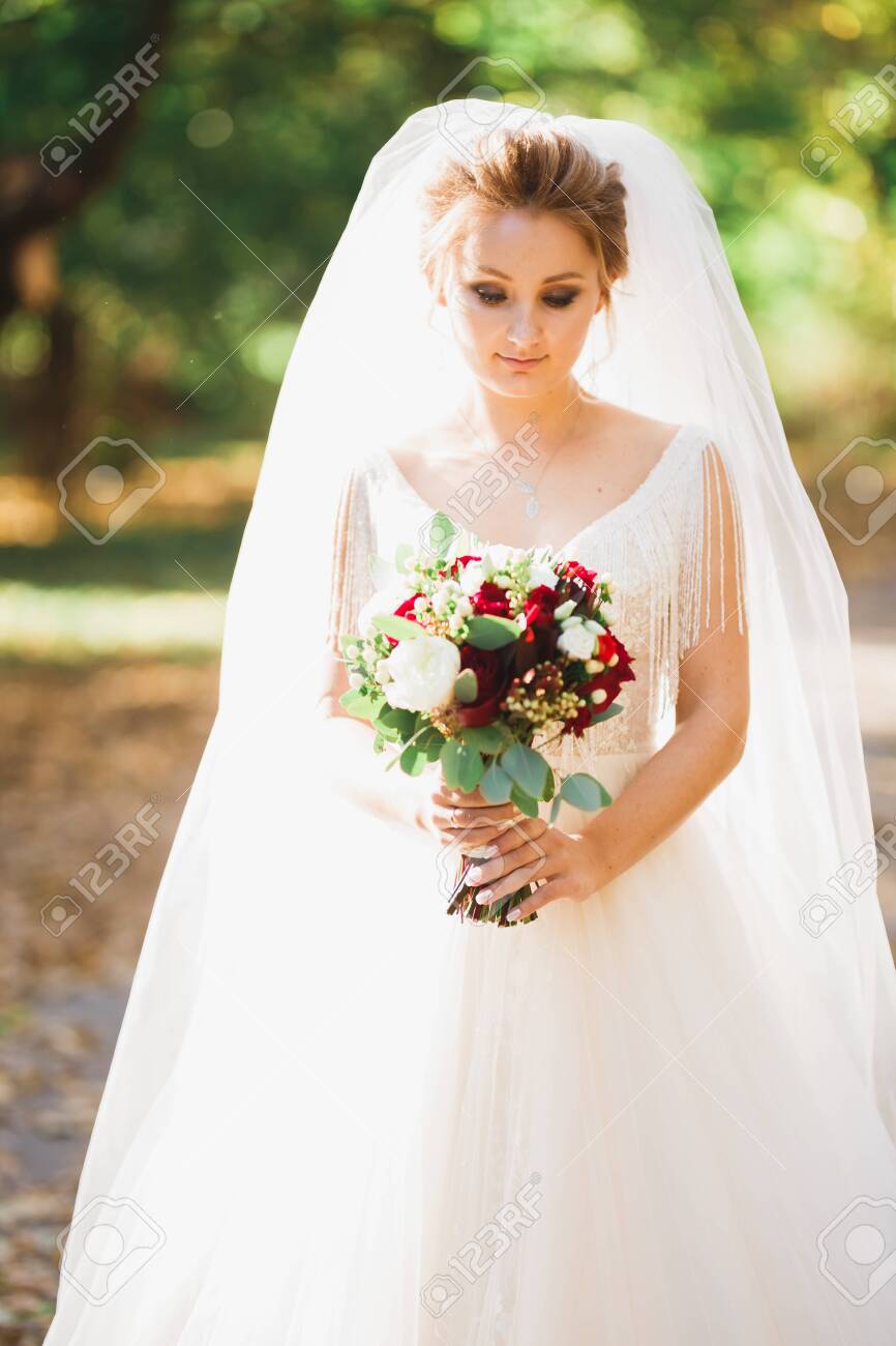 Luxury wedding bride, girl posing and smiling with bouquet - 144509155 Luxury wedding bride, girl posing and smiling with bouquet - 144509155