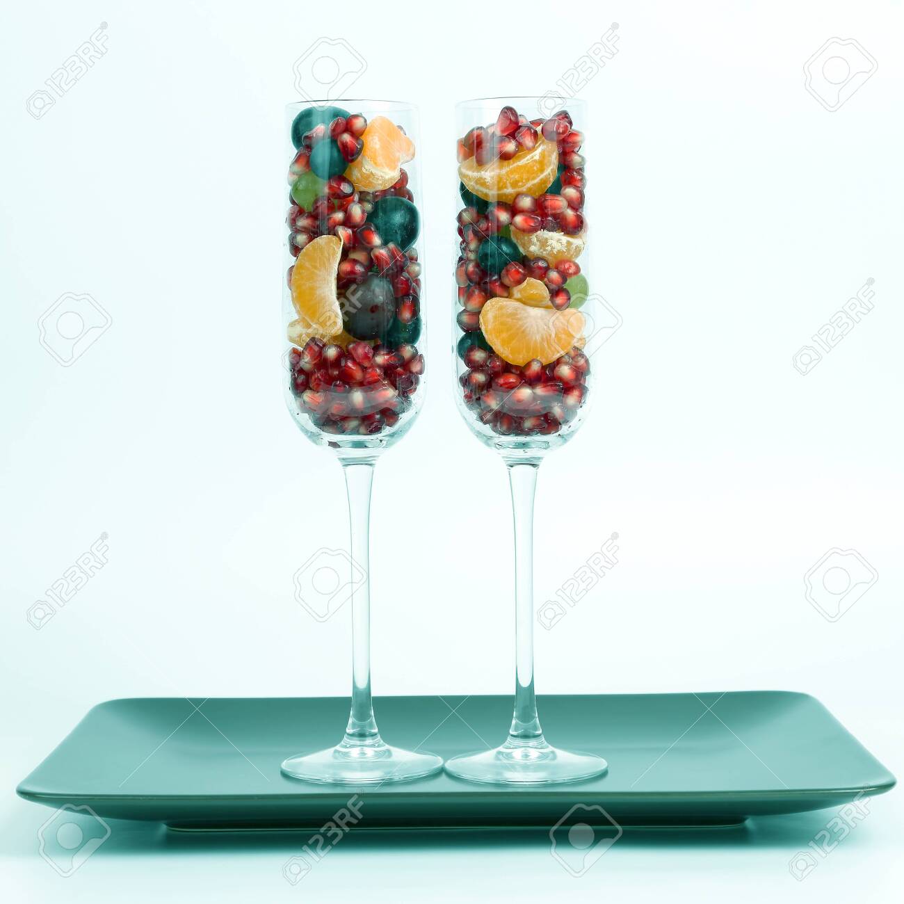 two glasses filled with fruit on a light background. healthy fresh vegetables and food - 125138691 two glasses filled with fruit on a light background. healthy fresh vegetables and food - 125138691