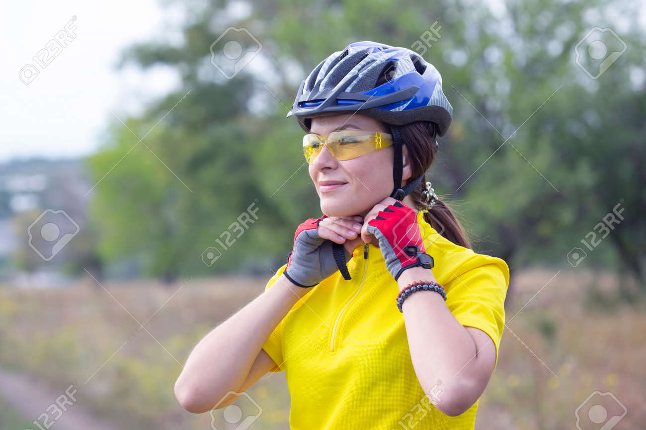 Beautiful and happy girl cyclist on nature. Healthy lifestyle and sports. Leisure and hobbies - 153320218 Beautiful and happy girl cyclist on nature. Healthy lifestyle and sports. Leisure and hobbies - 153320218