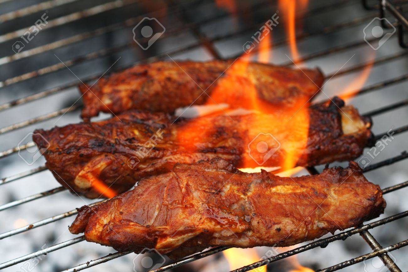 flame bbq marinated juicy pork ribs on griil summer barbeque