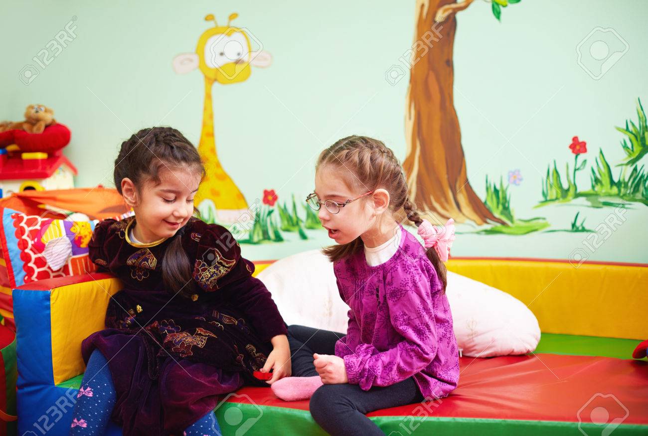 かわいい女の子の話と 特別なニーズを持つ子供のための幼稚園で遊んで の写真素材 画像素材 Image