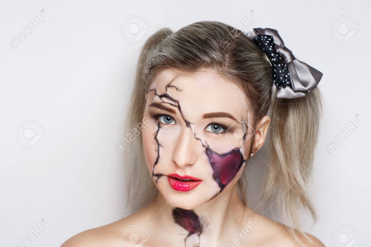 Femme Visage Brisé. Maquillage Sombre Créatif, Idée Conceptuelle Pour  Halloween. Cauchemar Inquiétant Se Transformant En Un Vampire Noir, Le  Volume Crache La Peinture D'art Corporel. Photo Professionnelle Fond Gris  Horizontal Banque D'images