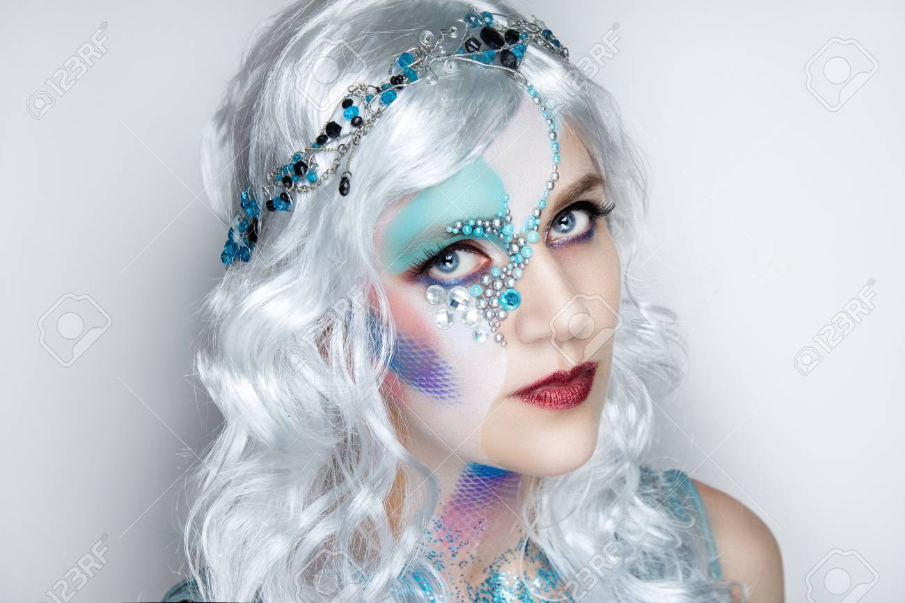 Beautiful Mermaid Girl In White Wig Curly Hair. Professional Makeup Artist  Make-up, Implement Different Images. Turn Into A Silver Water Fairy By  Cosmetics. Creative Body Art, Personal Vision Of Style Stock Photo,