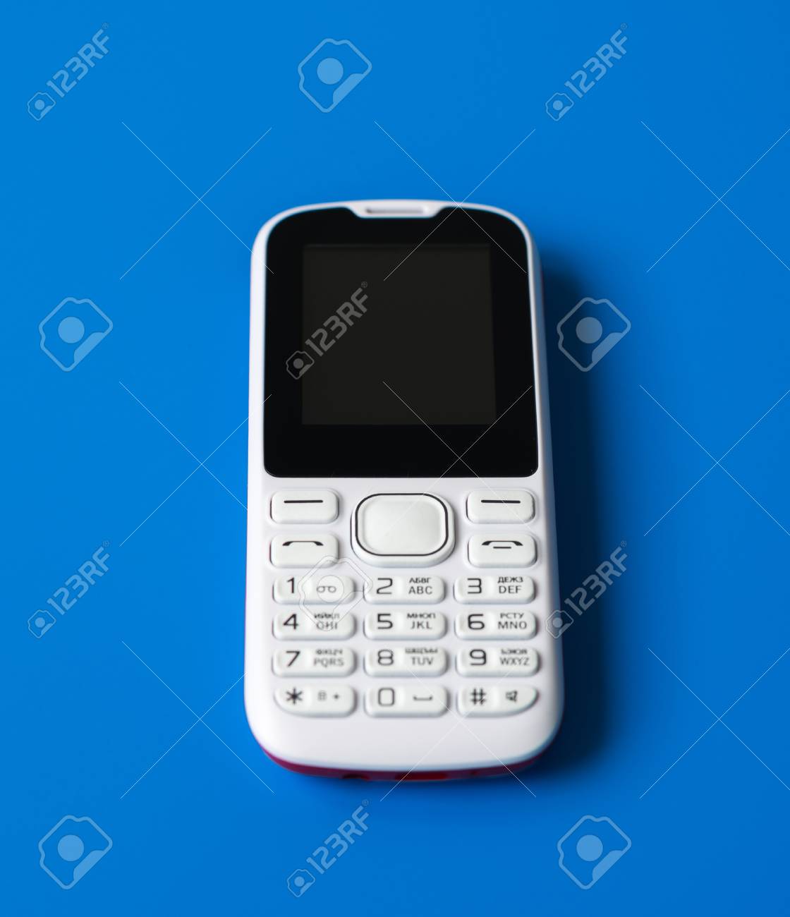 White Cell Phone With Buttons On A Blue Background Stock Photo Picture And Royalty Free Image Image 94450951