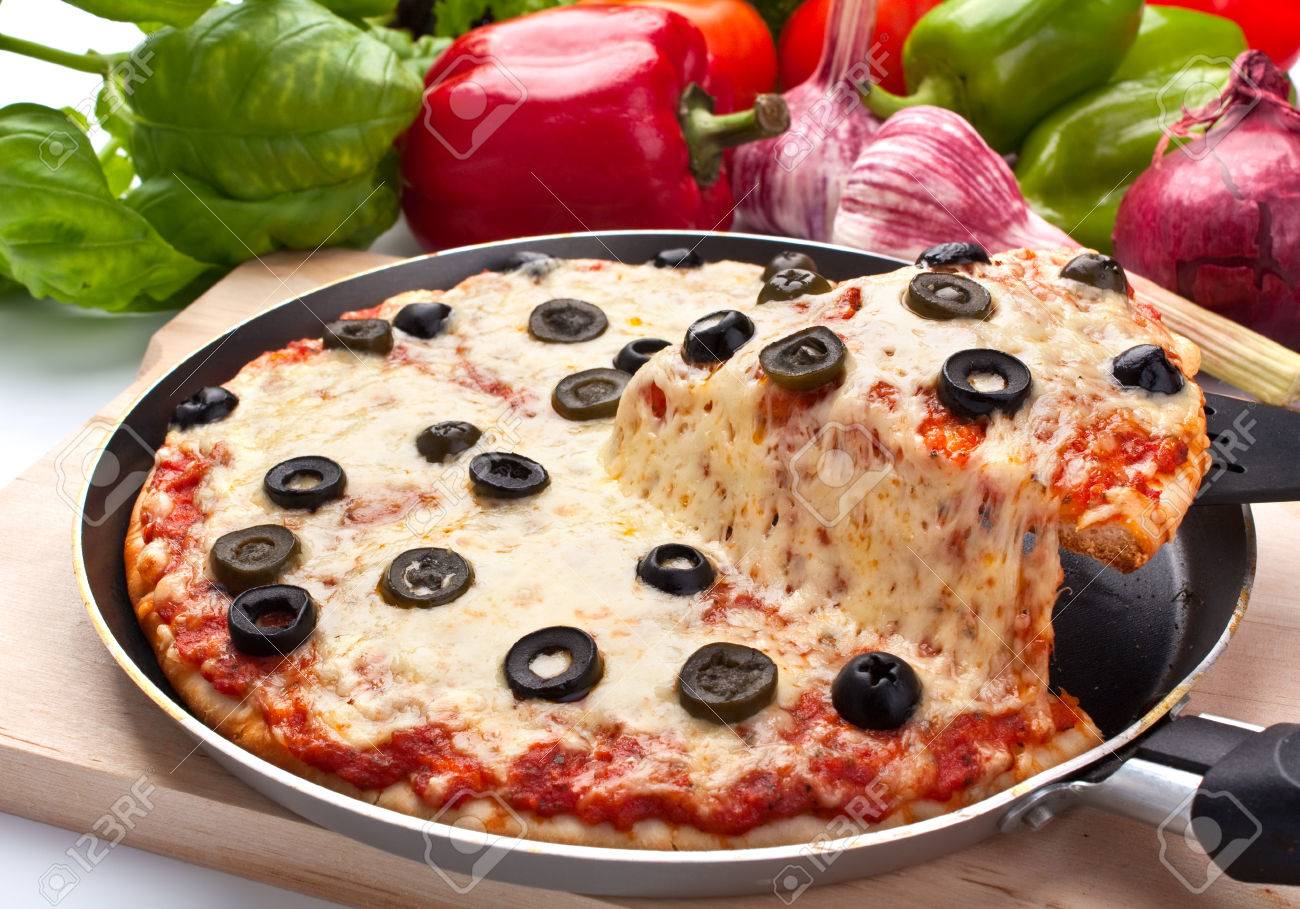 Sliced Cheese And Black Olive Pizza With Ingredients One Slice Lifted Up Stock Photo, Picture And Royalty Free Image. Image 31592807.