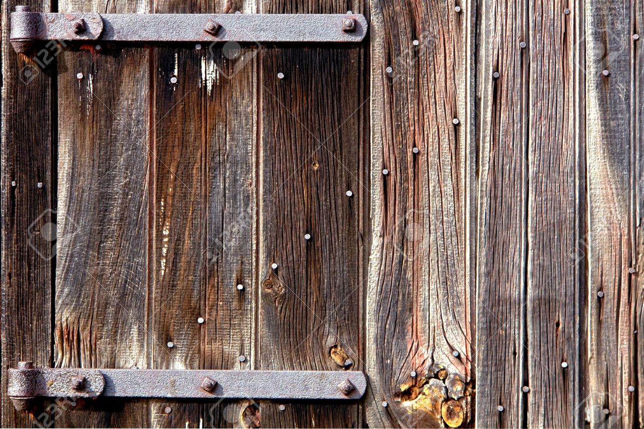 Weathered Old Wood Barn Door With Vintage Iron Hinges Stock Photo Stock Photo - Weathered old wood barn door with vintage iron hinges - Weathered Old Wood Barn Door With Vintage Iron Hinges Stock Photo