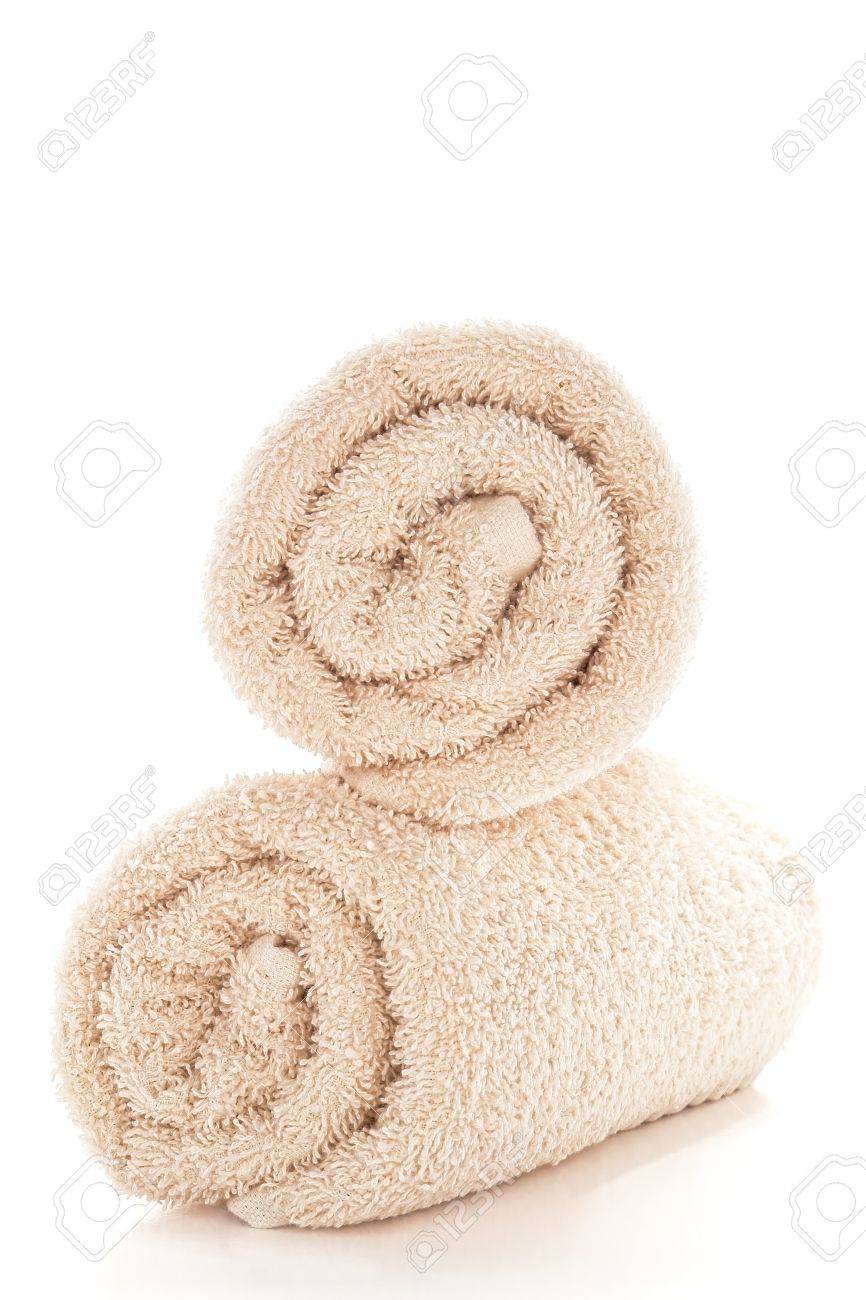 soft and fluffy beige color cotton bath towels rolled and stacked
