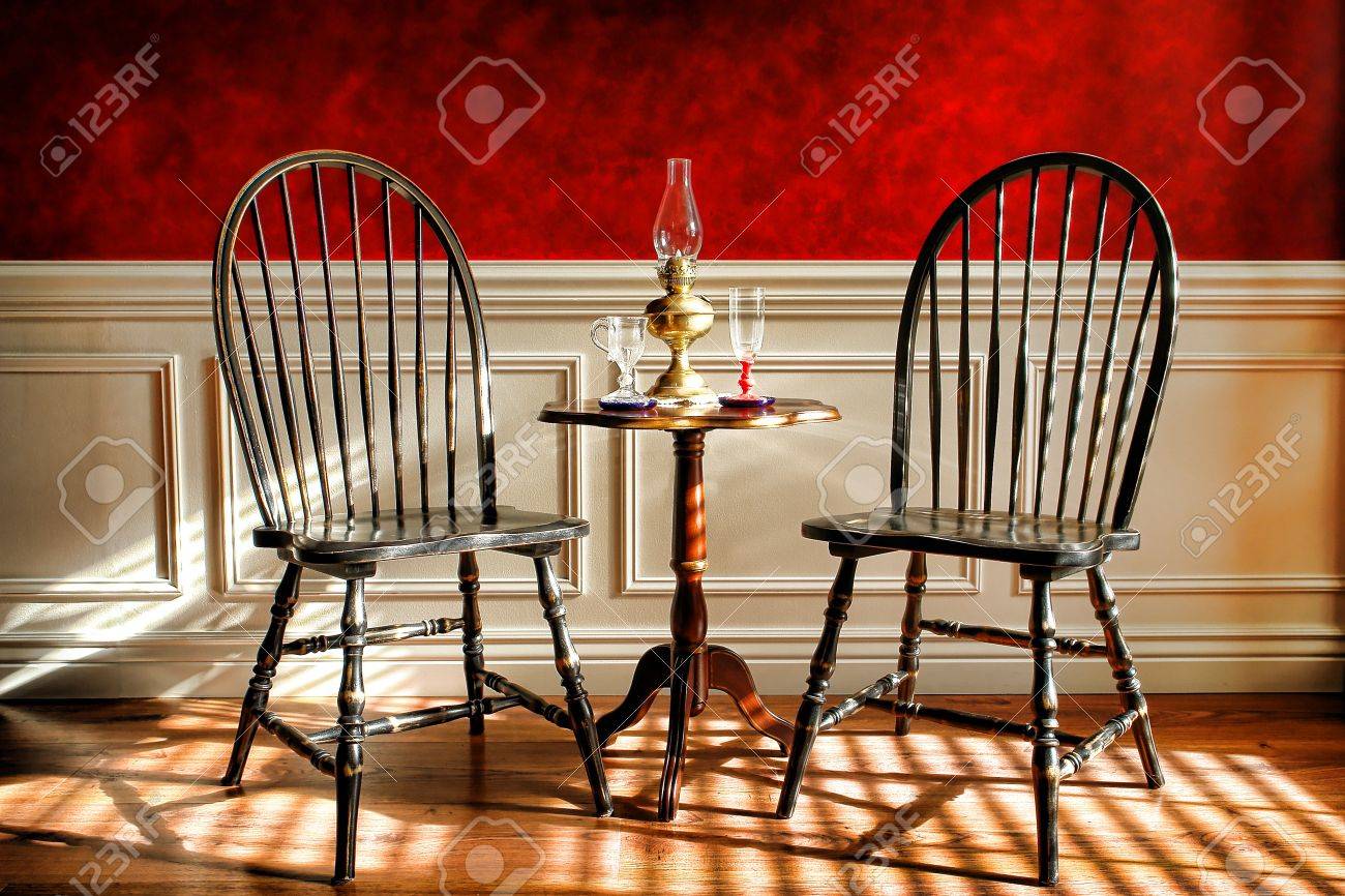 antique black distressed windsor style chairs and mahogany table