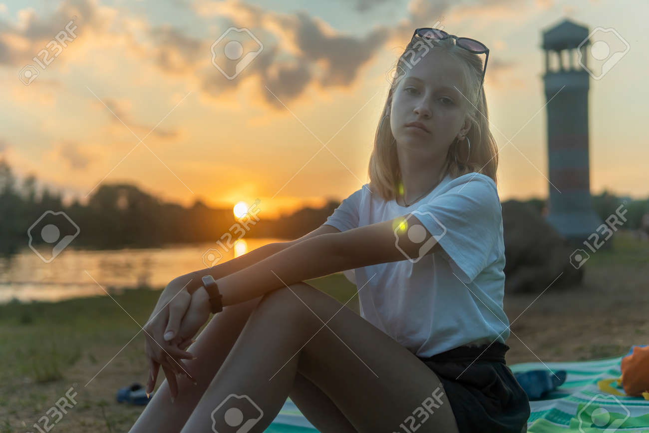 teen girls at a lake Blonde Teen Girl Sitting By The Lake In The Park And Resting. Stock Photo,  Picture and Royalty Free Image. Image 179383230.