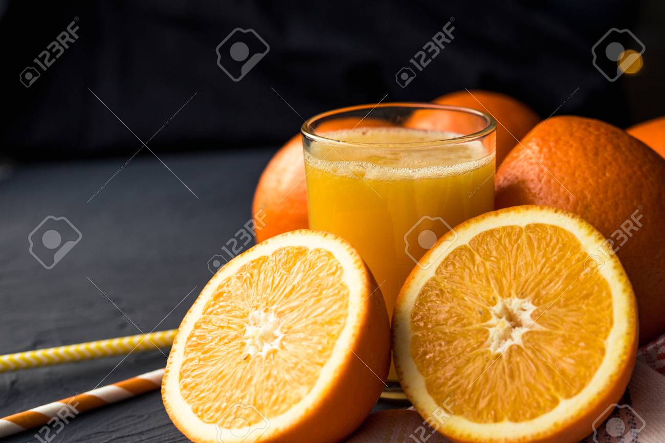 Fresh orange juice and fresh fruit oranges on a black background - 119103145 Fresh orange juice and fresh fruit oranges on a black background - 119103145