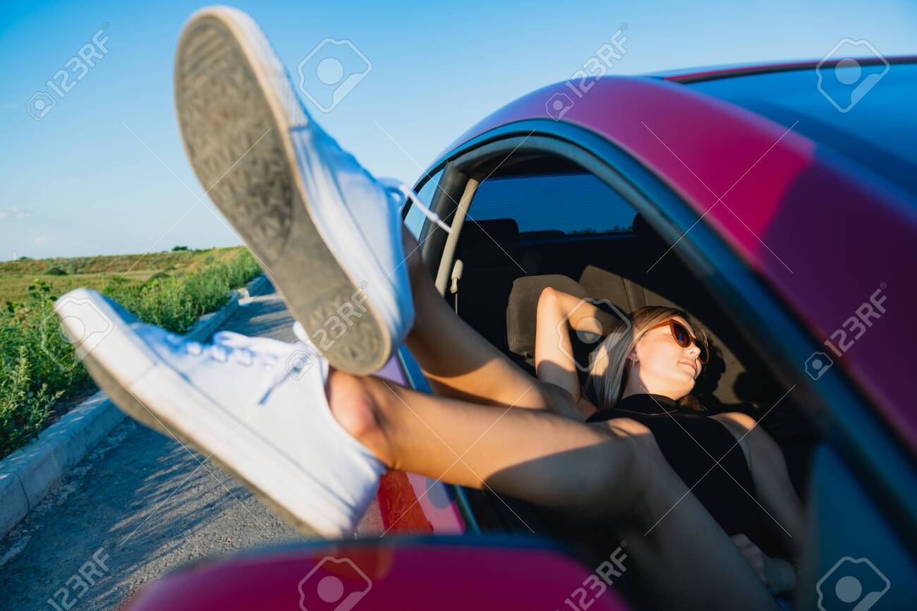 Young Female Blonde Traveler Lay Down At Car Seat And Stick Out Stock Photo Picture And Royalty Free Image Image 152709170
