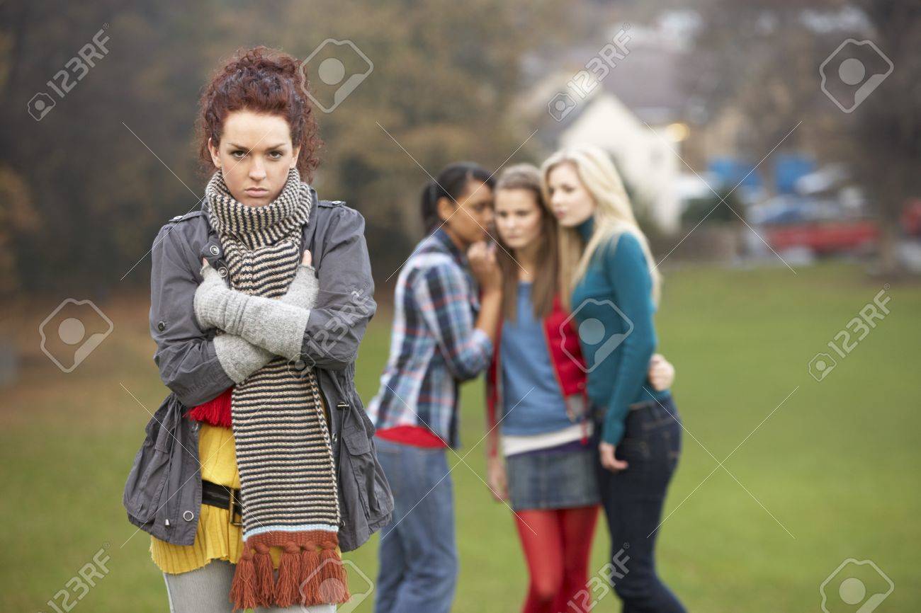 Upset Teenage Girl With Friends Gossiping In Background Stock Photo Picture And Royalty Free Image Image