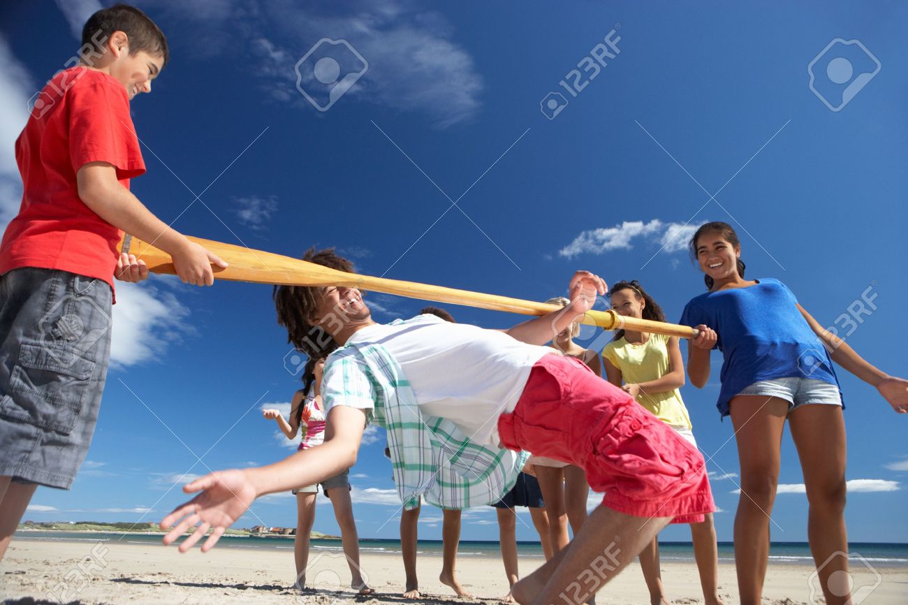 Teenagers Doing Limbo Dance On Beach Stock Photo, Picture And ...
