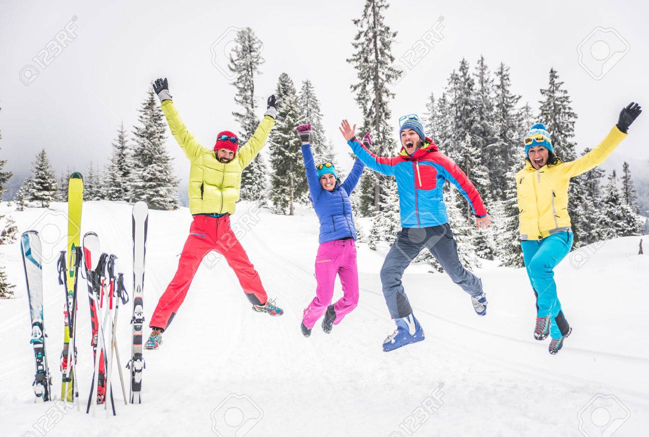 Group of skiers jumping and having fun - 48131732 Group of skiers jumping and having fun - 48131732