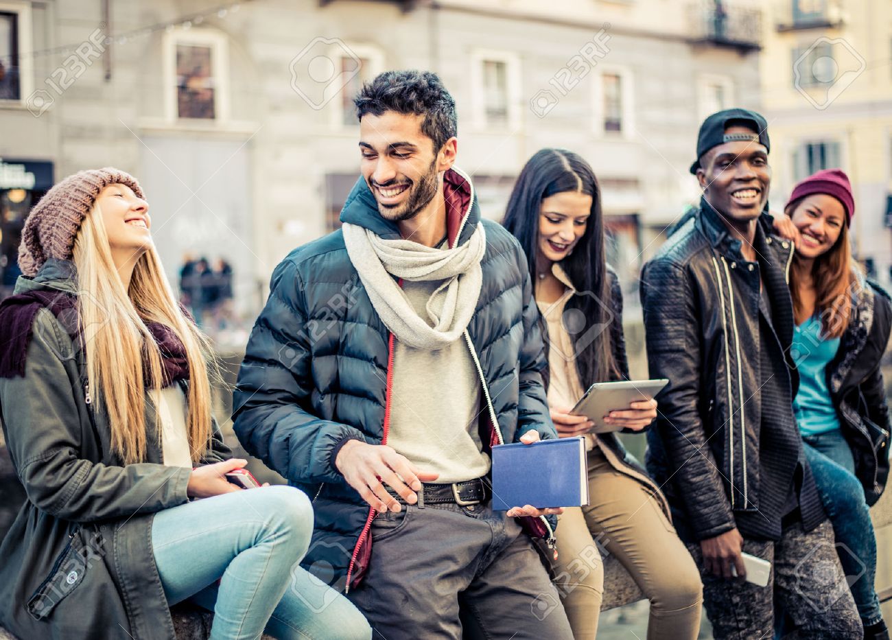 group of multi ethnic friends walking on the streets and smiling