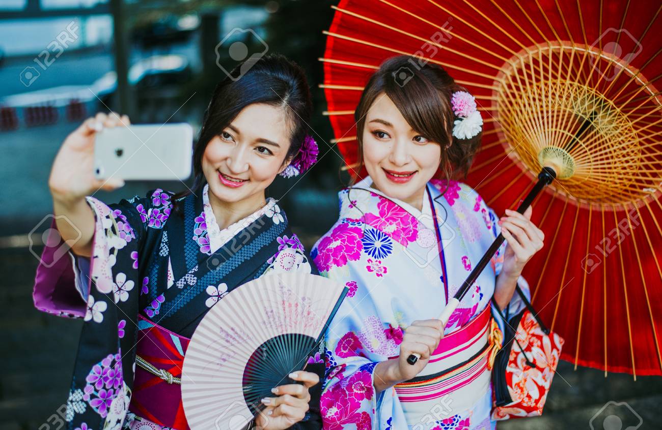 Two japanese girls wearing kimonos traditional clothes, lifestyle moments -...