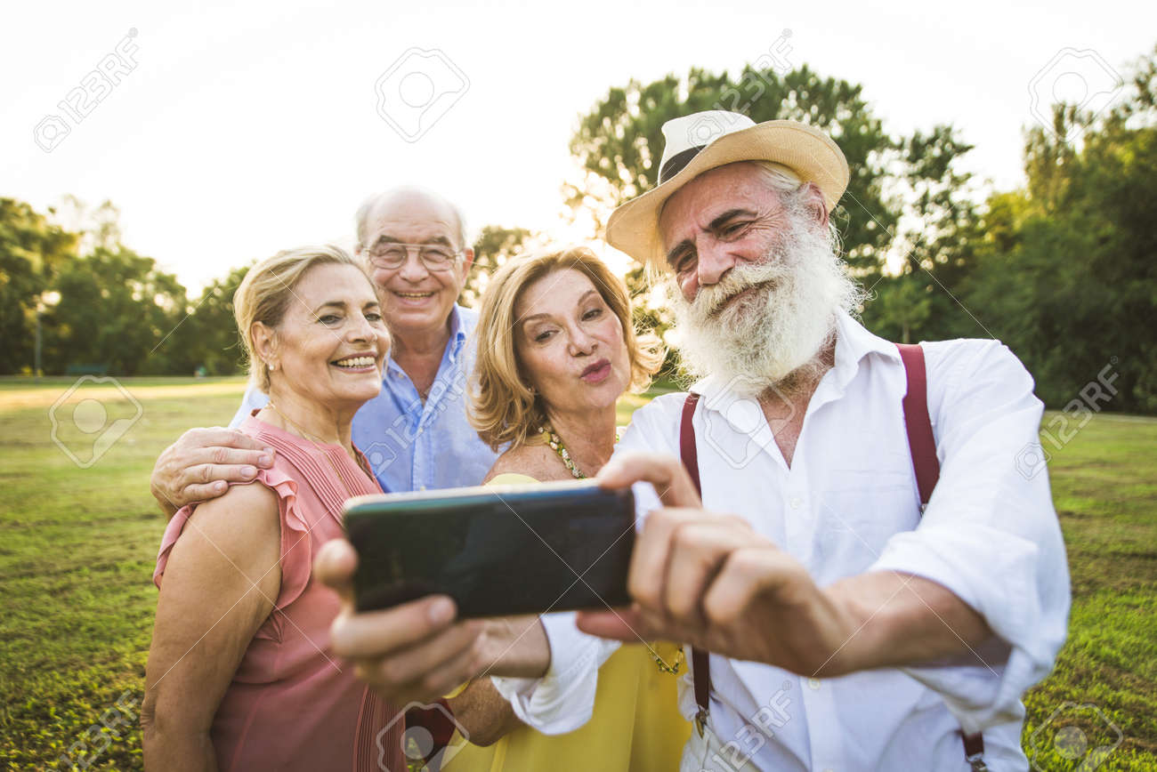 Group of youthful seniors having fun outdoors - Four pensioners bonding outdoors, concepts about lifestyle and elderly - 155169552 Group of youthful seniors having fun outdoors - Four pensioners bonding outdoors, concepts about lifestyle and elderly - 155169552