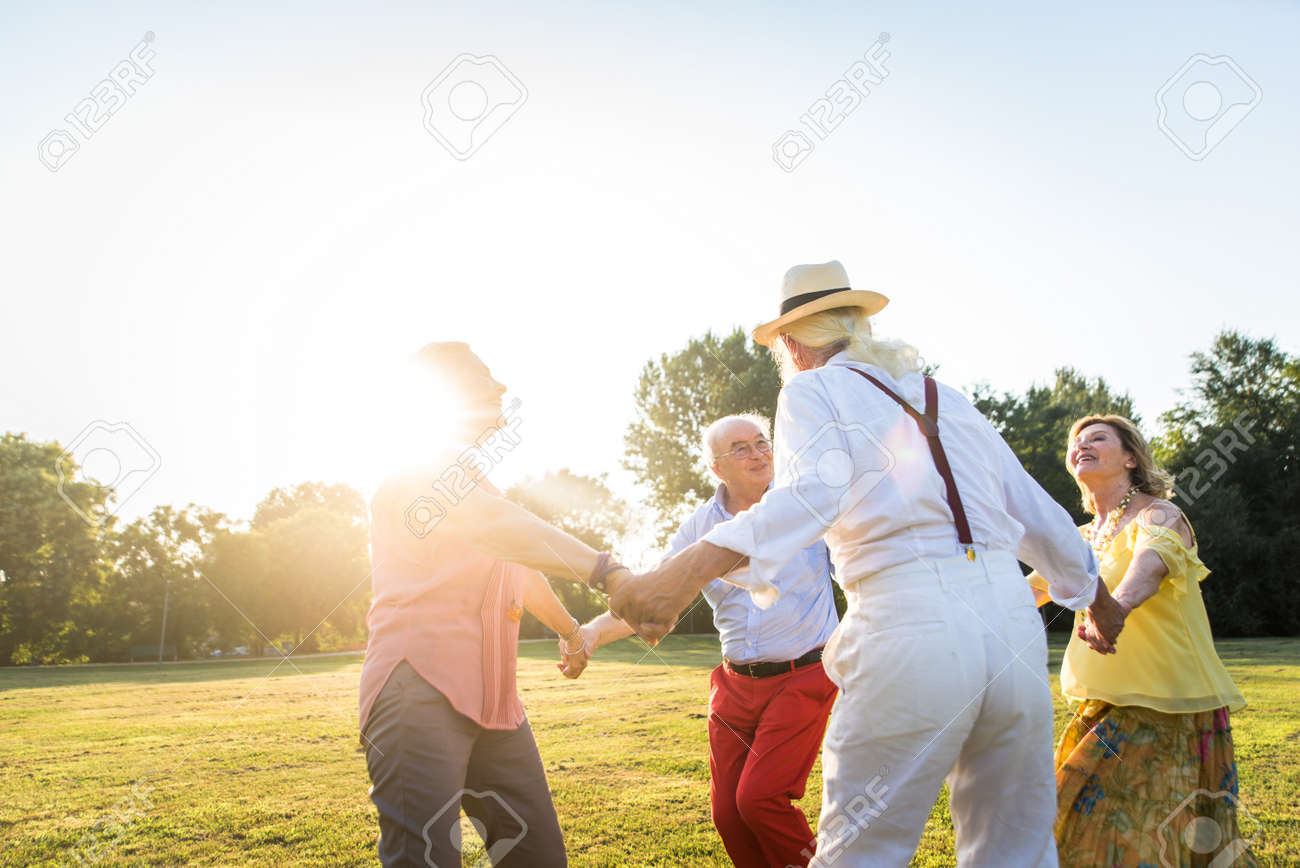 Group of youthful seniors having fun outdoors - Four pensioners bonding outdoors, concepts about lifestyle and elderly - 155170399 Group of youthful seniors having fun outdoors - Four pensioners bonding outdoors, concepts about lifestyle and elderly - 155170399