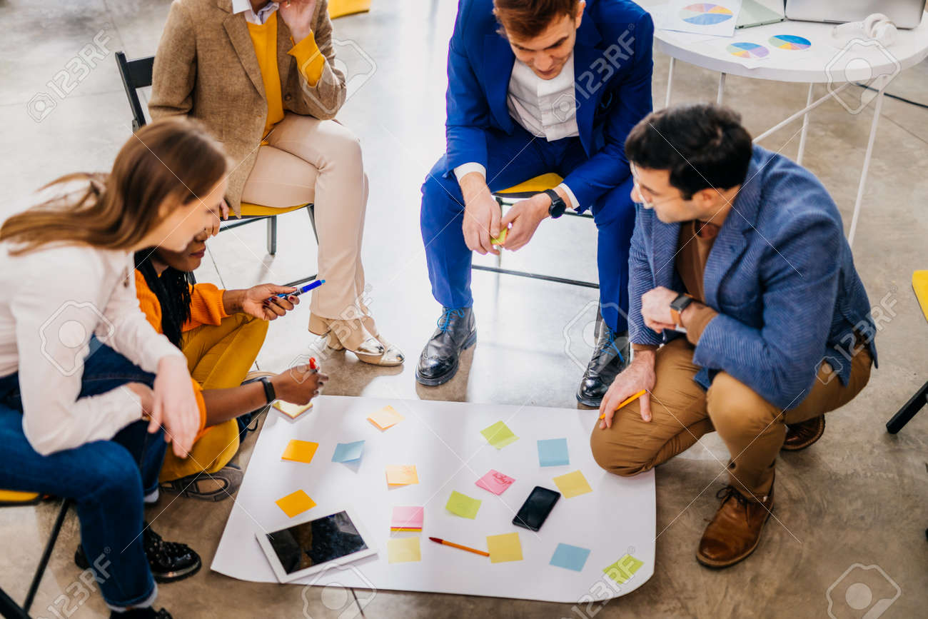 Project managers and employees brainstorming on ideas - Multi-ethnic group of workers having business meeting in a start-up office - 168140608 Project managers and employees brainstorming on ideas - Multi-ethnic group of workers having business meeting in a start-up office - 168140608