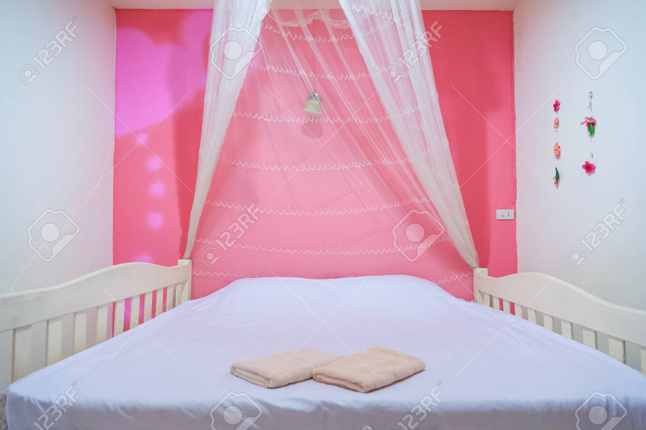 Beautiful Girls Room In Bright Pink Color With Carved Wood Bed