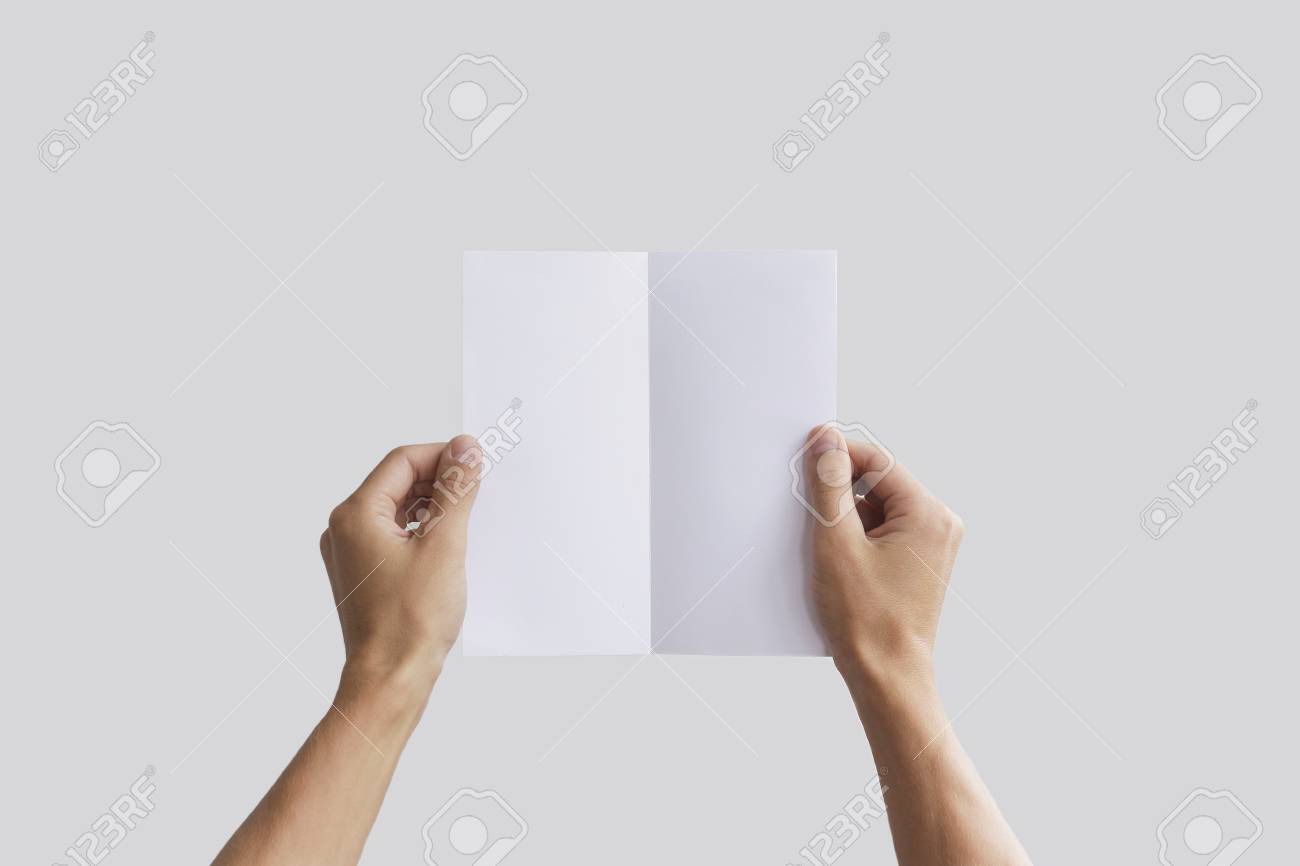 hand holding blank brochure booklet in the hand leaflet