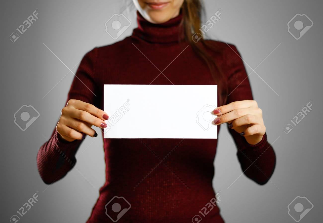 woman showing blank white flyer paper leaflet presentation stock